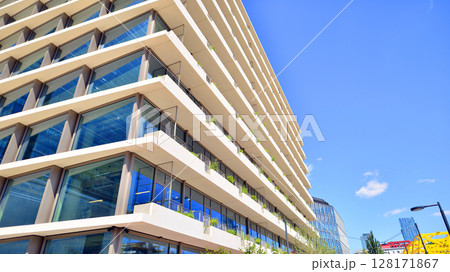 Downtown corporate business district architecture. Glass reflective office buildings against blue sky and sun light. Economy, finances, business activity concept. Abstract modern architecture fragment 128171867