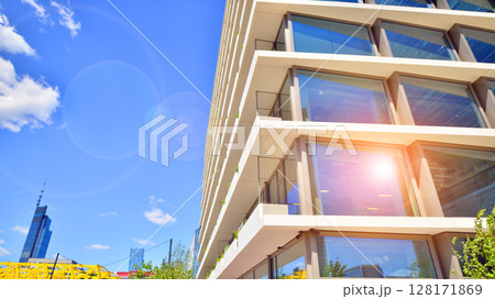 Downtown corporate business district architecture. Glass reflective office buildings against blue sky and sun light. Economy, finances, business activity concept. Abstract modern architecture fragment Downtown corporate business district architecture. Glass reflective office buildings against blue sky and sun light. Economy, finances, business activity concept. Abstract modern architecture fragment 128171869
