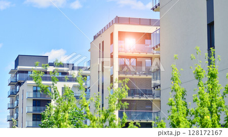 European residential architecture harmonizing with nature. Eco-friendly living in city with greens. Eco apartment building saving energy and fresh air concept.  128172167