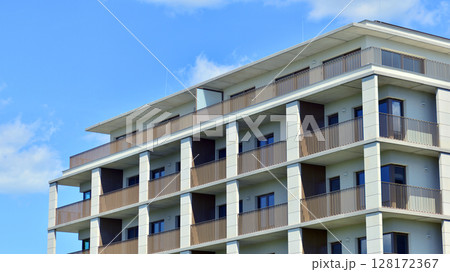 Modern apartment buildings on a sunny day with a blue sky. Facade of a modern apartment building. Modern residential apartment building complex condo. Modern apartment buildings on a sunny day with a blue sky. Facade of a modern apartment building. Modern residential apartment building complex condo. 128172367