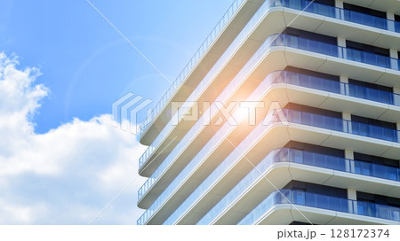 Modern apartment buildings on a sunny day with a blue sky. Facade of a modern apartment building. Modern residential apartment building complex condo. 128172374