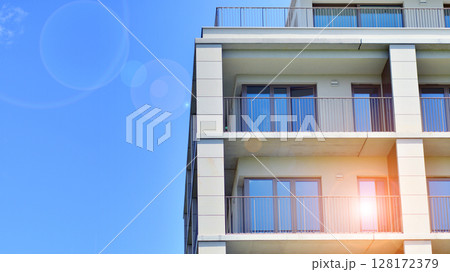 Modern apartment buildings on a sunny day with a blue sky. Facade of a modern apartment building. Modern residential apartment building complex condo. 128172379