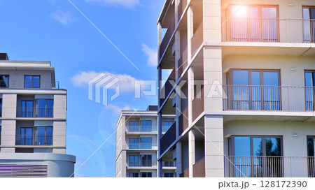 Modern apartment buildings on a sunny day with a blue sky. Facade of a modern apartment building. Modern residential apartment building complex condo. Modern apartment buildings on a sunny day with a blue sky. Facade of a modern apartment building. Modern residential apartment building complex condo. 128172390