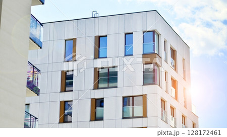 Modern apartment buildings on a sunny day with a blue sky. Facade of a modern apartment building. Modern residential apartment building complex condo. 128172461