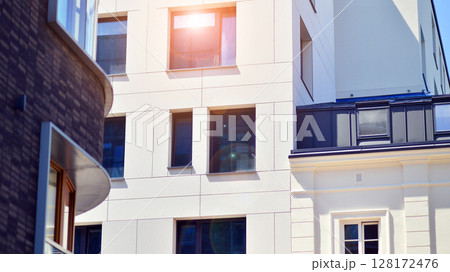 Modern apartment buildings on a sunny day with a blue sky. Facade of a modern apartment building. Modern residential apartment building complex condo. Modern apartment buildings on a sunny day with a blue sky. Facade of a modern apartment building. Modern residential apartment building complex condo. 128172476