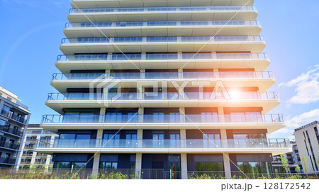 Exterior of a high modern multi-story apartment building - facade, windows and balconies. Exterior of a high modern multi-story apartment building - facade, windows and balconies. 128172542