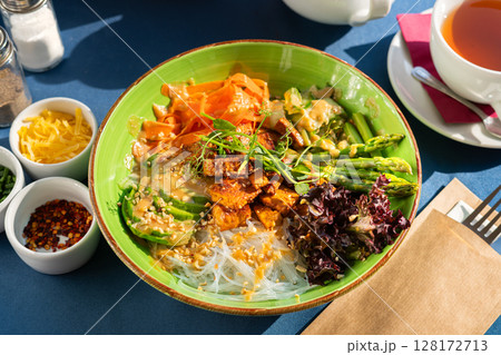 Soft boiled eggs served with toast and pesto with avocado and red onion, served on a beautiful blue and white plate. A breakfast set illuminated by the morning sun. Soft boiled eggs served with toast and pesto with avocado and red onion, served on a beautiful blue and white plate. A breakfast set illuminated by the morning sun. 128172713