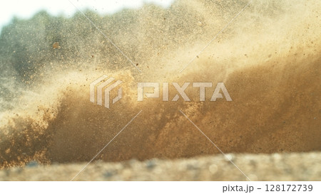 Detail view of flying dust particles into the air. Freeze motion of exploding clay. 128172739