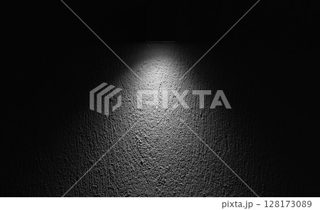 A focused spotlight highlighting the texture of a rough wall surface A focused spotlight highlighting the texture of a rough wall surface 128173089