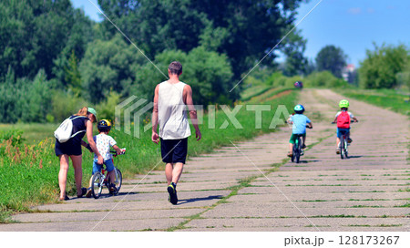 Family walking along the road on nature travel 128173267