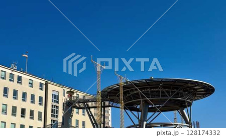 A Modern Communication Tower Set Against a Clear Blue Sky, Showcasing Urban Innovation and Design 128174332