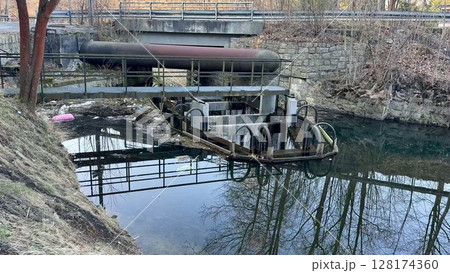 A Tranquil Waterway Scene Featuring an Industrial Structure, with Beautiful Reflections A Tranquil Waterway Scene Featuring an Industrial Structure, with Beautiful Reflections 128174360