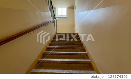 Exploring Stairway Perspective Bathed in Soft, Warm Lighting for a Captivating Atmosphere 128174391