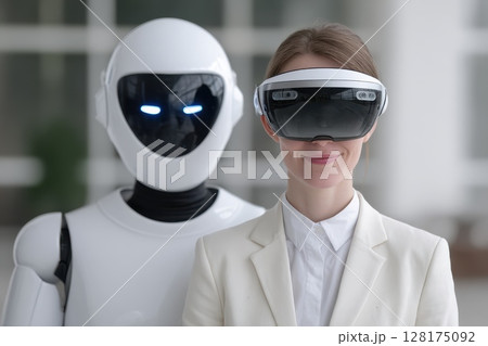A woman is standing next to a robot wearing a virtual reality headset 128175092