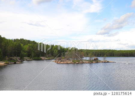 a lake with rocky islands and pine forest a lake with rocky islands and pine forest 128175614