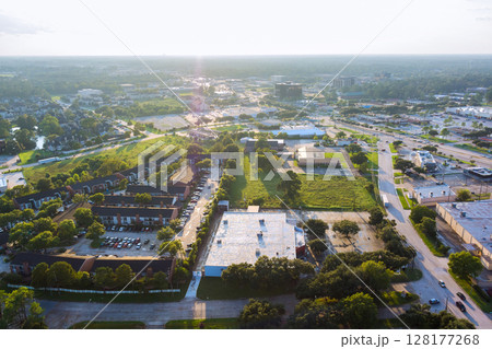 Panoramic view of Houston suburban area in Harris County, Texas, residential buildings, parking lots, green spaces, urban infrastructure commercial residential wide roadways. 128177268