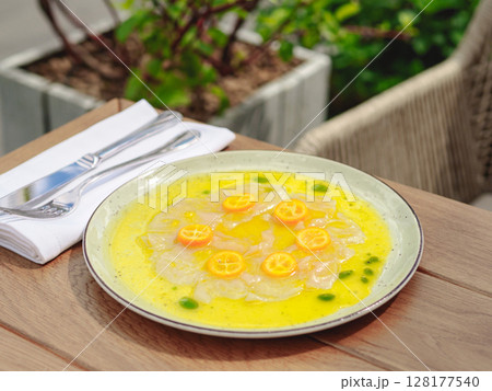 Fresh sea bream carpaccio with salad on white plate Fresh sea bream carpaccio with salad on white plate 128177540