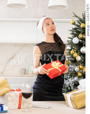 smartly dressed girl is waiting for Christmas at home 128177875