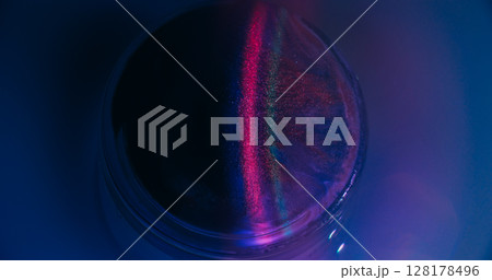 Neon spill. Gleam art. Defocused purple pink blue circle ink bright texture vibrant rainbow stripes floating on abstract fluorescent background. 128178496