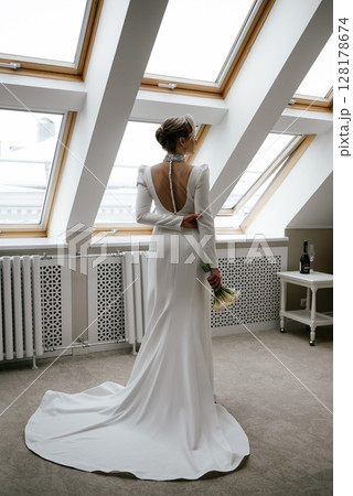 Elegant Bride Admiring Skyline in Backless Wedding Dress Elegant Bride Admiring Skyline in Backless Wedding Dress 128178674