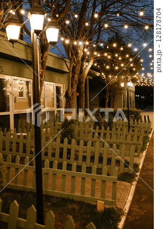 Enchanting Evening Garden with String Lights Across Path Enchanting Evening Garden with String Lights Across Path 128178704