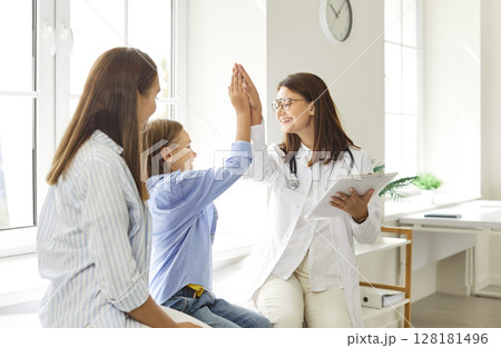 Doctor Giving High Five To Boy At Medical Consultation With Mother 128181496