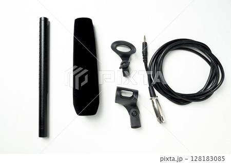 Studio microphone for podcasting or streaming with audio cable and a set of mic stands on a white background. Top view Studio microphone for podcasting or streaming with audio cable and a set of mic stands on a white background. Top view 128183085