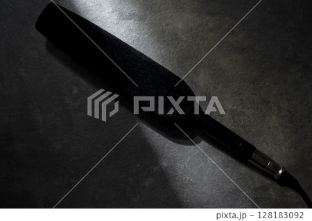 Studio microphone for podcasting or streaming with a black background. Top view Studio microphone for podcasting or streaming with a black background. Top view 128183092