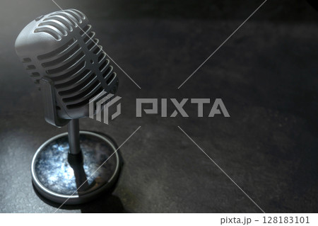 Vintage silver microphone with a black background Vintage silver microphone with a black background 128183101