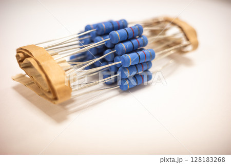 Close Up of Blue Film Resistors Bundled in Paper Tape for Electronics,Through Hole Resistors Close Up of Blue Film Resistors Bundled in Paper Tape for Electronics,Through Hole Resistors 128183268