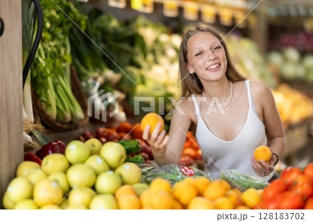 Blonde woman choosing peaches in the supermarket Blonde woman choosing peaches in the supermarket 128183702