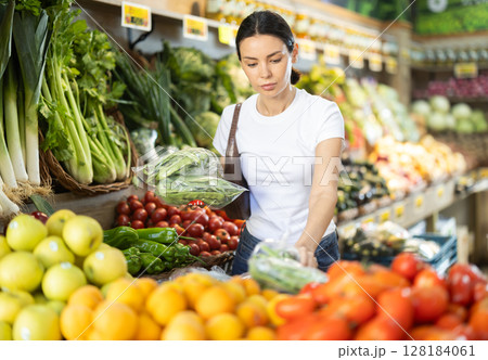 Woman buying edamame in a store Woman buying edamame in a store 128184061
