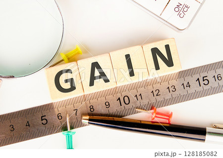 The concept word GAIN is assembled from cubes. Business and capital gains tax concept. Copy space 128185082