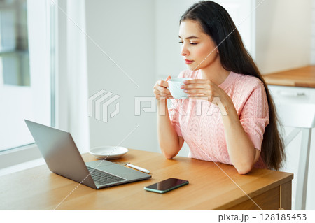 Woman working with laptop computer at home 128185453