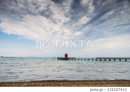 Pier and lighthouse on the sea, Lignano Sabbiadoro, Italy Pier and lighthouse on the sea, Lignano Sabbiadoro, Italy 128187413