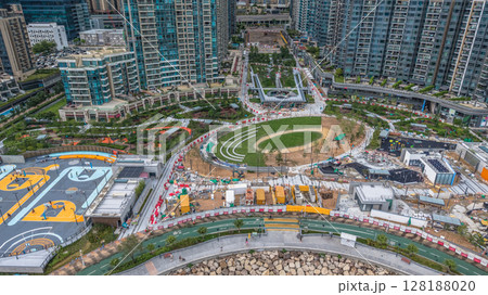 July 1 2025 Modern Urban Neighborhood with Green Space and High-Rise Buildings 128188020