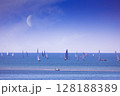 Sailing boats on sea with moon on blue sky, Grado, Italy 128188389