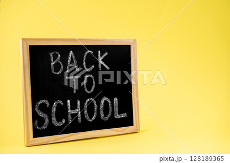 Rustic wooden-framed blackboard prominently displaying the classic BACK TO SCHOOL message, symbolizing renewed education and academic enthusiasm for students 128189365