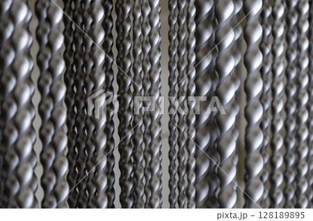 close-up of twisted metal rods with intricate patterns in industrial setting close-up of twisted metal rods with intricate patterns in industrial setting 128189895