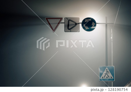 Road Signs in Fog at Night - Minimal Urban Composition Road Signs in Fog at Night - Minimal Urban Composition 128190754
