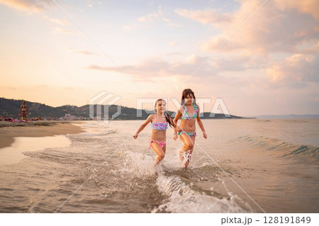 Joyful family moments at the beach during sunset activities Joyful family moments at the beach during sunset activities 128191849