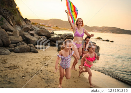 Joyful moments of a family flying kites and splashing at the beach Joyful moments of a family flying kites and splashing at the beach 128191856
