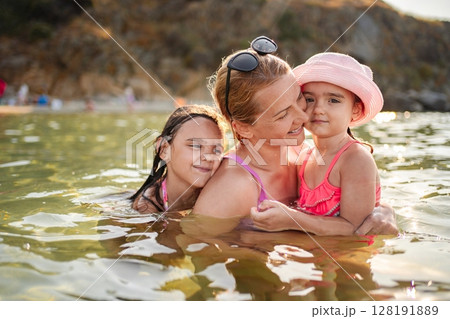 Joyful family moments at the beach on a sunny summer day Joyful family moments at the beach on a sunny summer day 128191889