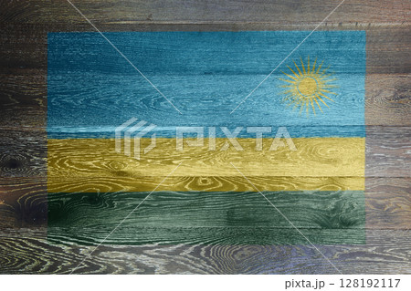 Rwanda flag on rustic old wood surface background 128192117
