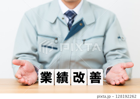 業績改善のブロックと作業着を着たミドル男性ビジネスマン 128192262