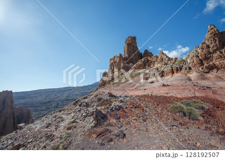 Tenerife mountain under blue sky with sun and clouds Tenerife mountain under blue sky with sun and clouds 128192507