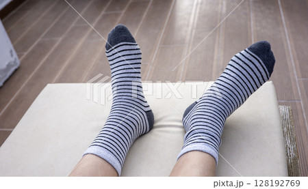 Gray socks with black stripes on boys feet Gray socks with black stripes on boys feet 128192769