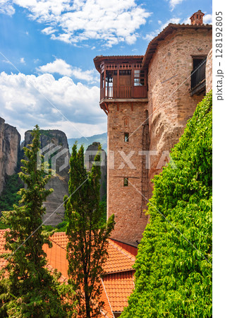 Historic monastery tower with wooden balcony overlooking cliffs in Meteora Greece Historic monastery tower with wooden balcony overlooking cliffs in Meteora Greece 128192805