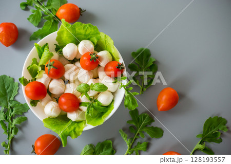 Delicious composition with mozzarella, cherry tomatoes and greens Delicious composition with mozzarella, cherry tomatoes and greens 128193557