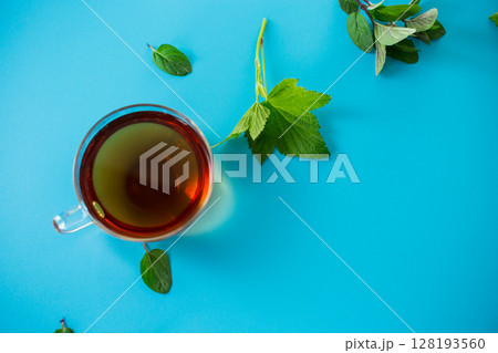 Refreshing herbal infusion in a glass cup and teapot Refreshing herbal infusion in a glass cup and teapot 128193560